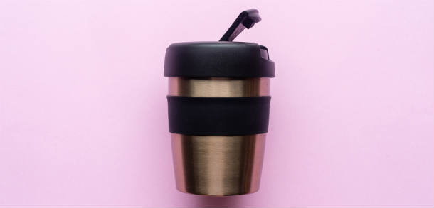 Reusable coffee cup with pink background