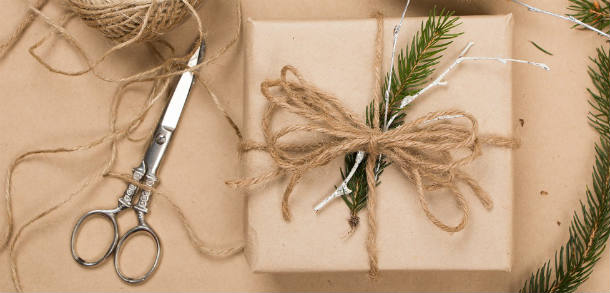 Gift wrapped using brown paper, natural colour twin and festive greenery