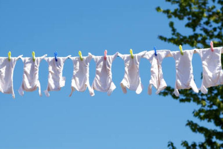 Washing line with many cloth nappies drying.