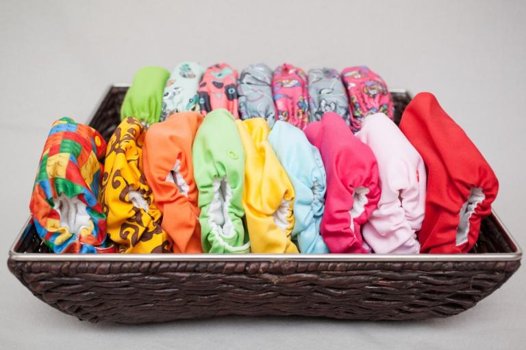 Colourful cloth nappies in basket.