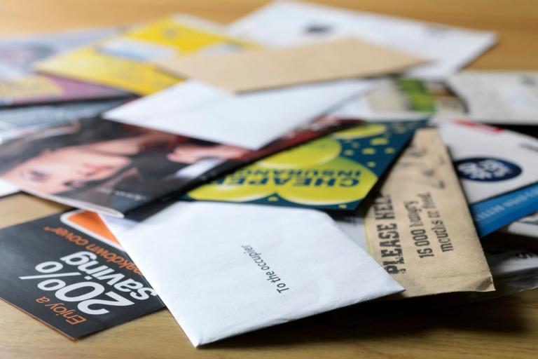 Pile of junk mail on the floor.