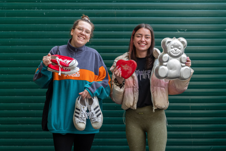 Two people holding shoes, tin and teddy baking mold.