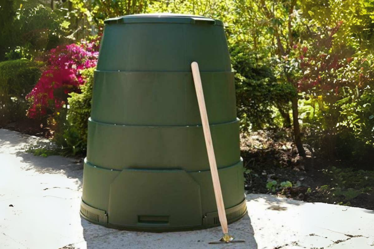 A Green Johanna compost bin in a garden.