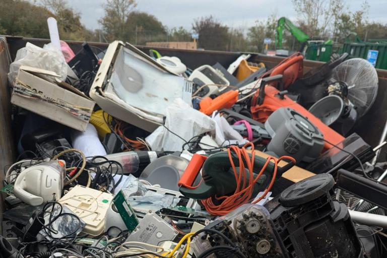 Waste electrical equipment in a container at a recycling centre.