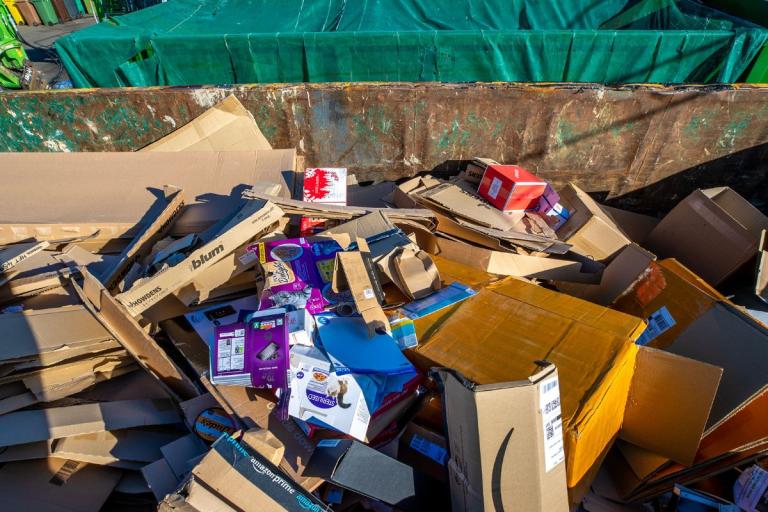 Cardboard in a large container at a recycling centre.