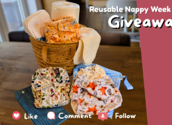 Text reads, ‘Reusable Nappy Week, Giveaway’. A photograph of a basket of cloth nappy items including, nappies, wipes and liners. The basket is sat on a kitchen counter. The words ‘like, comment and follow are at the bottom of the photo.